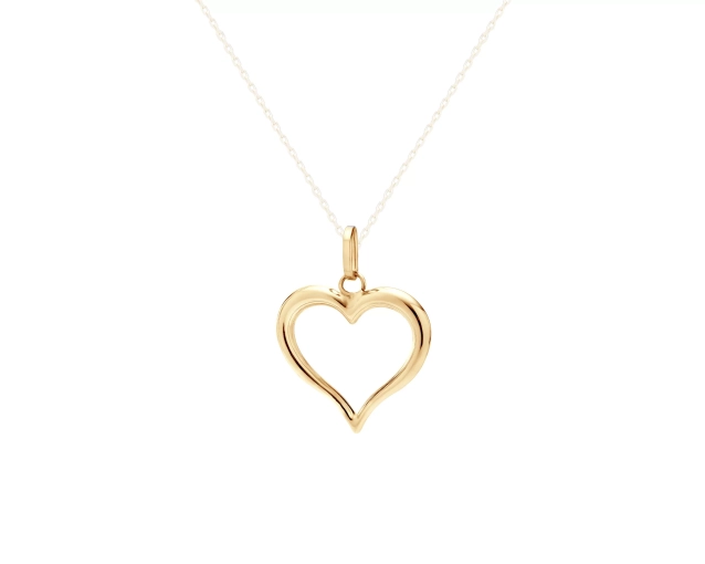 Zawieszka złota serce na gładkiej powierzchni